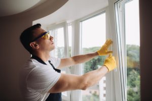 Maintenance,man,is,fixing,windows,in,a,living,room,using